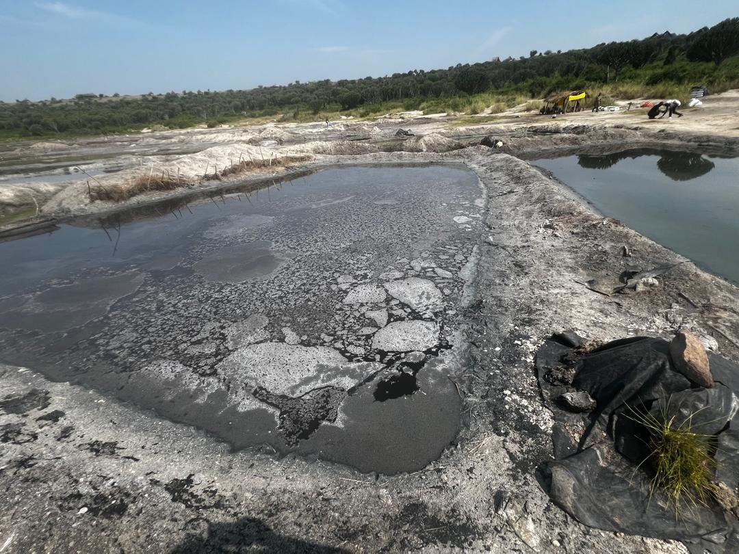 A salt pan with a crust of salt on the shore of Lake Katwe, Uganda