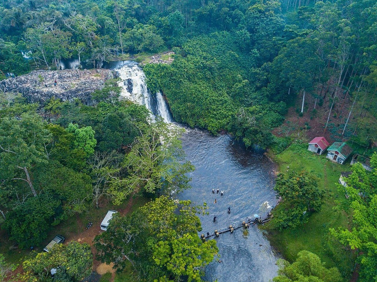 Aerial view of Ssezibwa Falls tumbling into the river, surrounded by forest and gardens