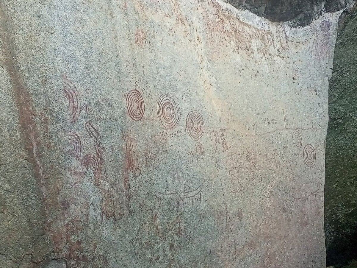 Red concentric-circle paintings on a granite rock face at the Nyero rock art site in eastern Uganda